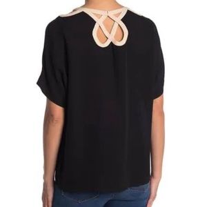 Black Diane Von Furstenberg blouse with ornate neckline